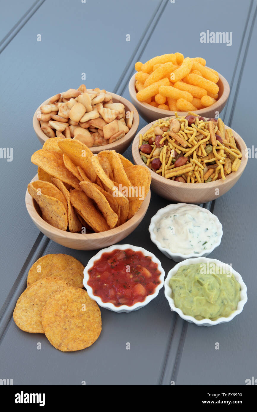 Savory snack and dip party food selection in wooden bowls and porcelain