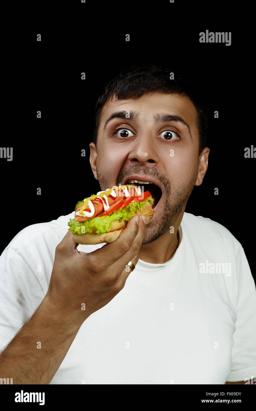 Armenian man eating hotdog Stock Photo