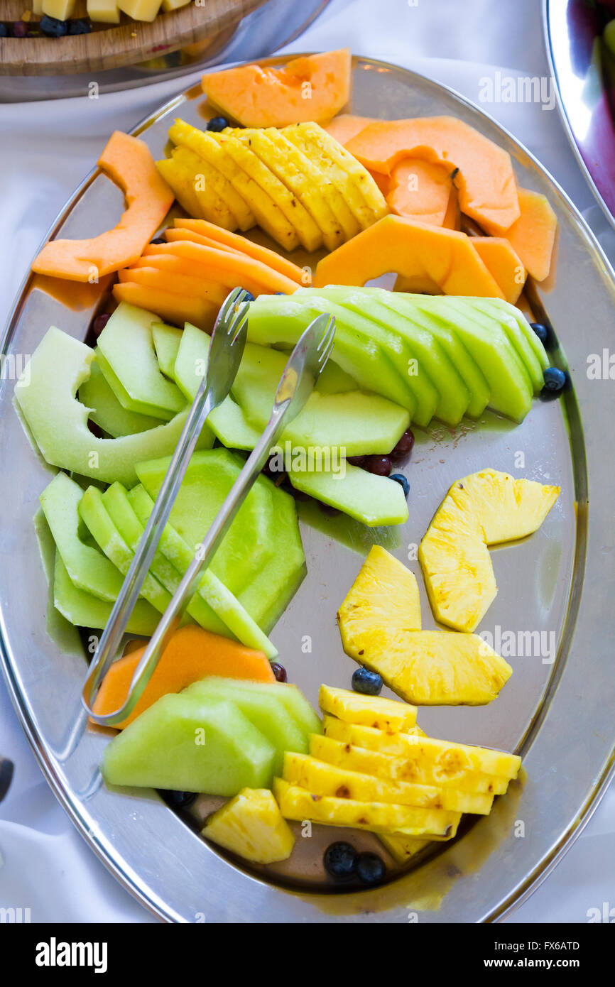 Fruit plate or platter at a wedding reception with melon and pineapple. Stock Photo
