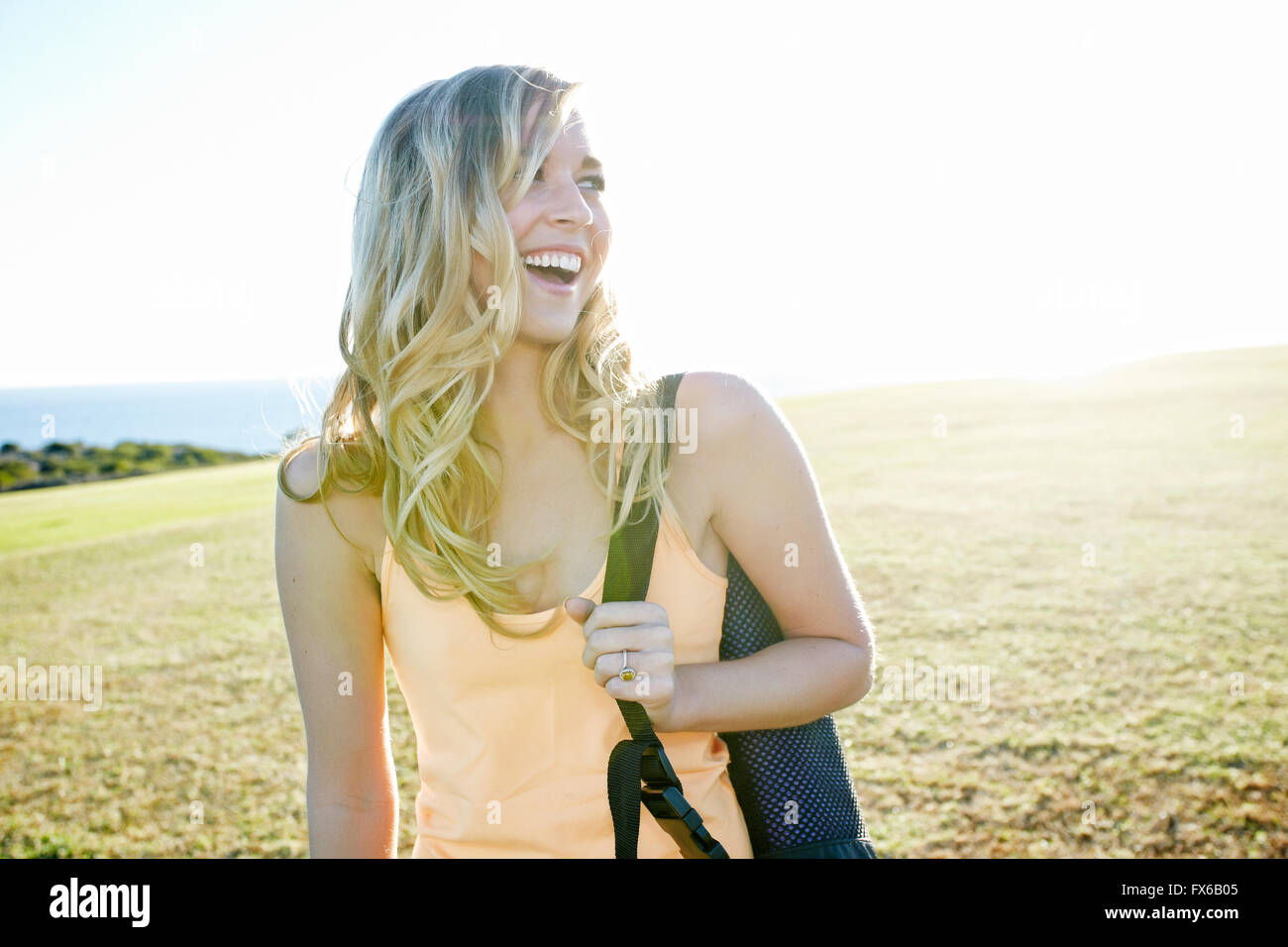 Caucasian woman laughing in field Stock Photo