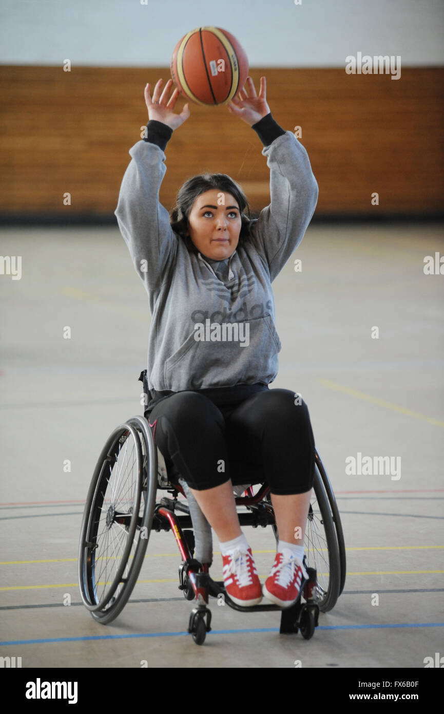 A disabled woman in a wheelchair throwing a basketball Stock Photo Alamy