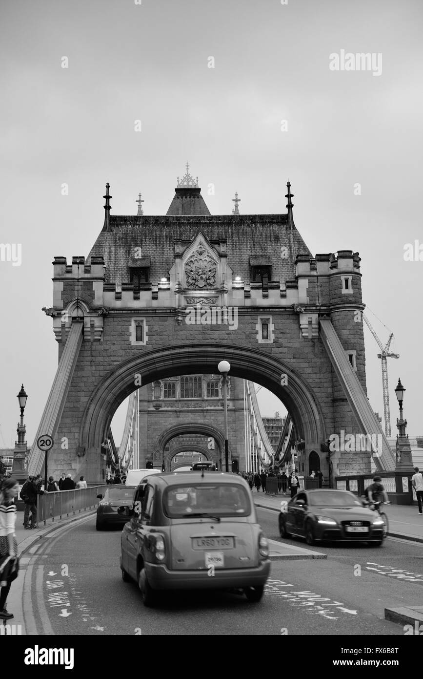 LONDON, UK - SEP 25: Tower Bridge with tourists and traffic on September 25, 2013 in London, UK. It is one of the iconic architectures in London and one of the most famous bridges in the world. Stock Photo
