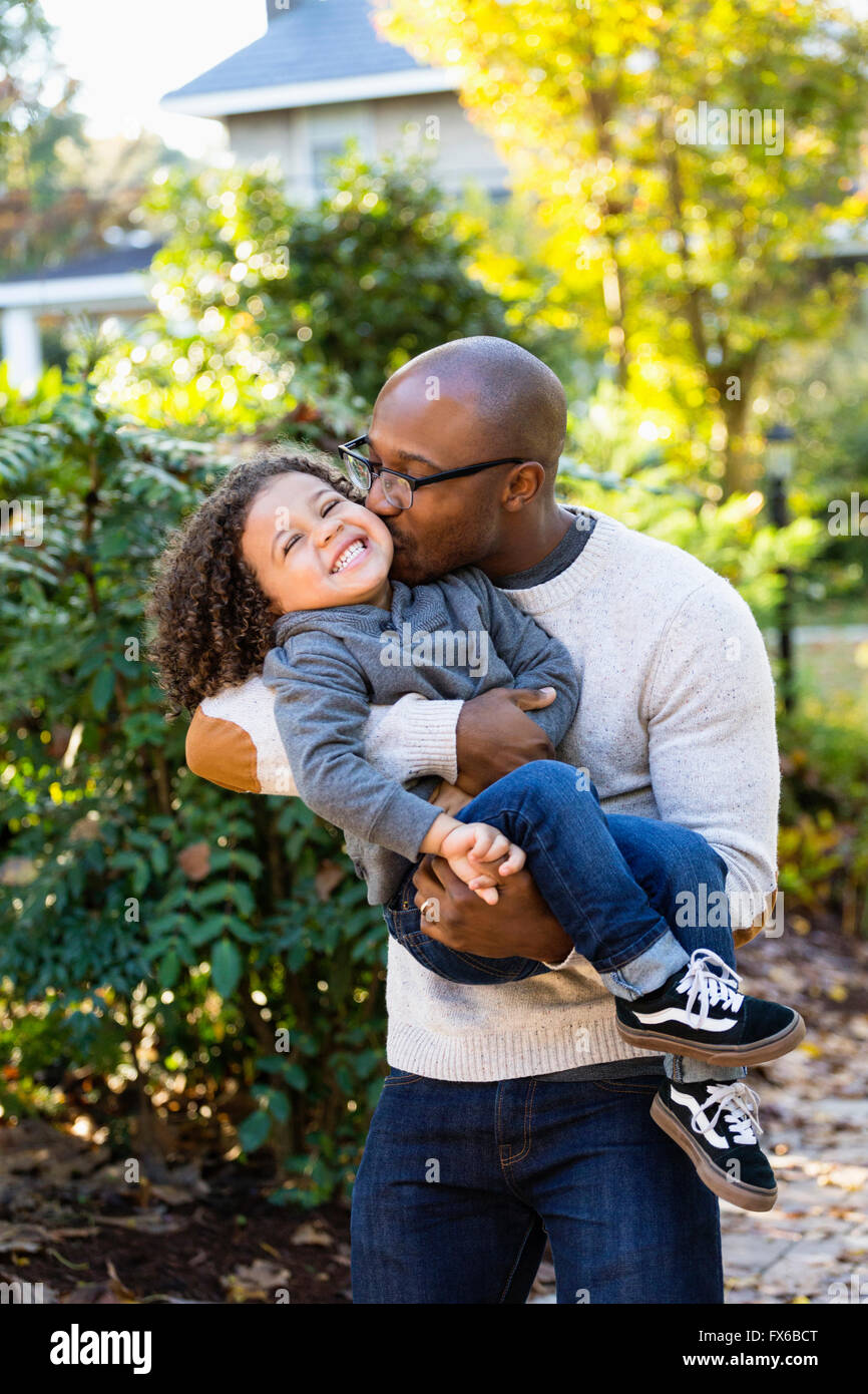 Father kissing son outdoors Stock Photo