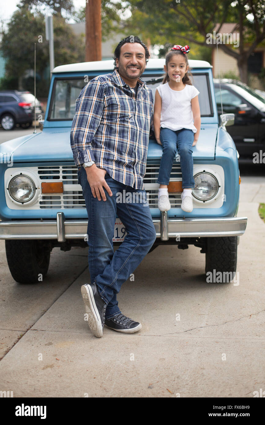Hispanic father and daughter near truck Stock Photo