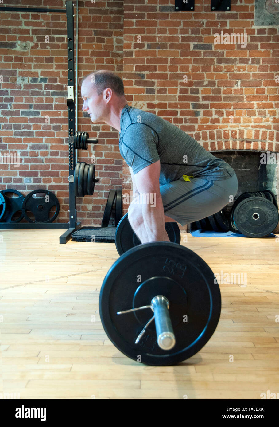 Man lifting weights standing hires stock photography and images Alamy