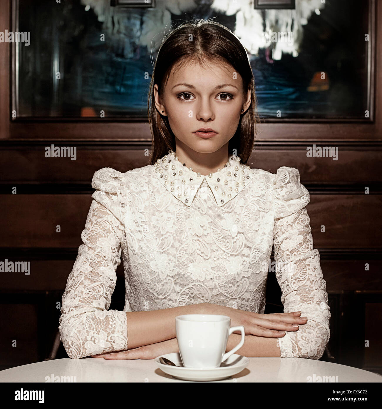 Caucasian teenage girl drinking coffee in restaurant Stock Photo
