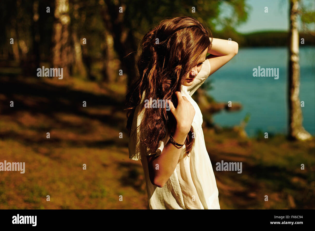Caucasian woman standing near rural lake Stock Photo - Alamy