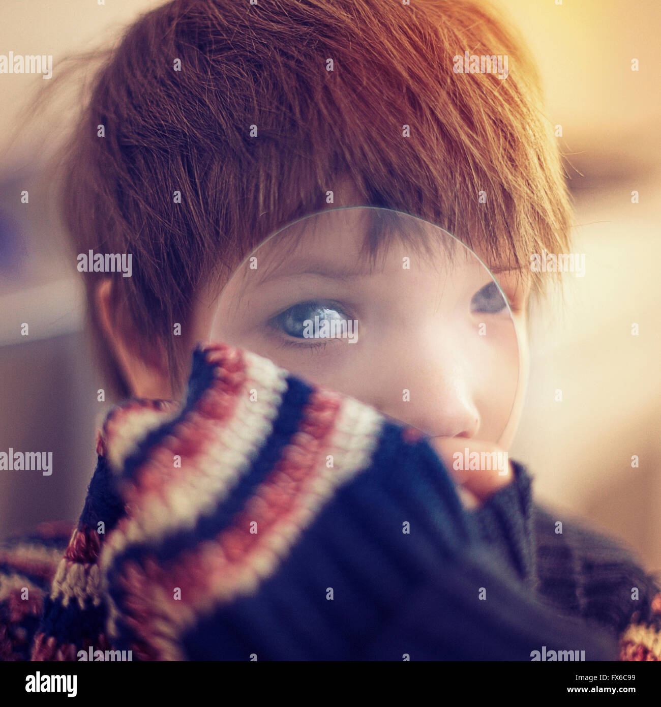 Caucasian girl looking through magnifying glass Stock Photo