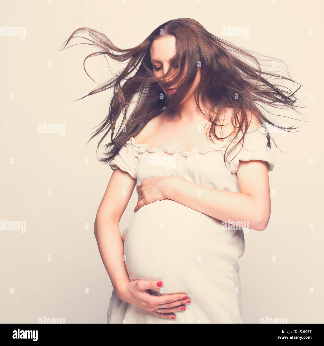Pregnant Caucasian woman hugging her belly Stock Photo - Alamy