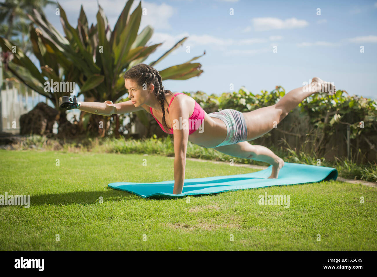 Mixed race amputee practicing yoga in grass Stock Photo