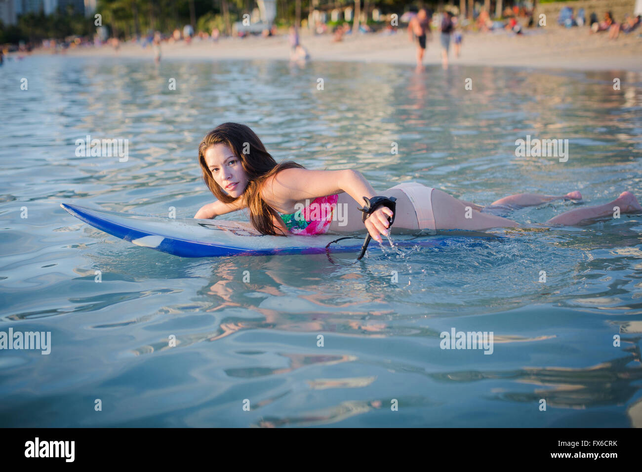 Mixed race amputee swimming with surfboard Stock Photo