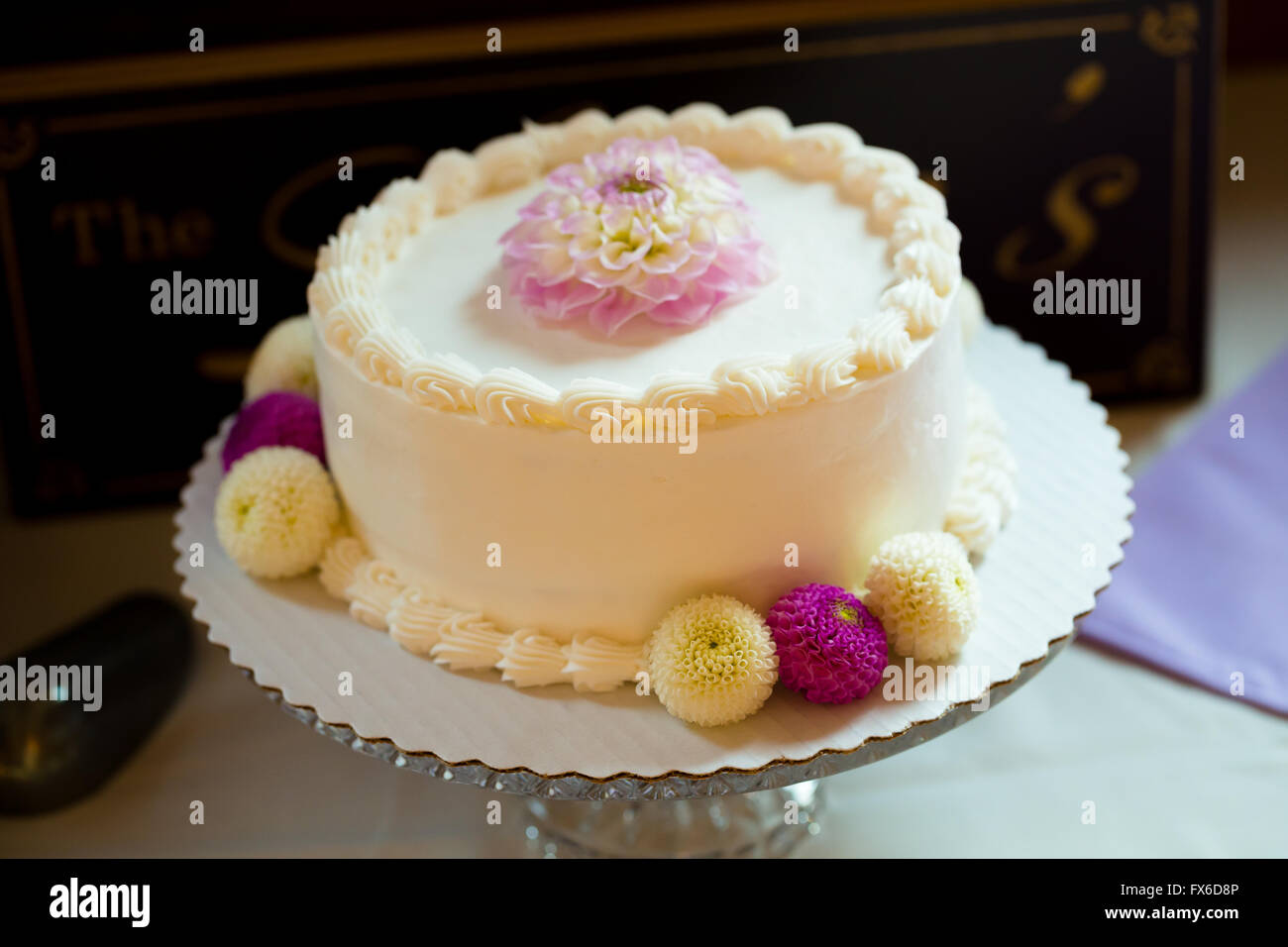 Cake stand holding a special white wedding cake for the bride and groom