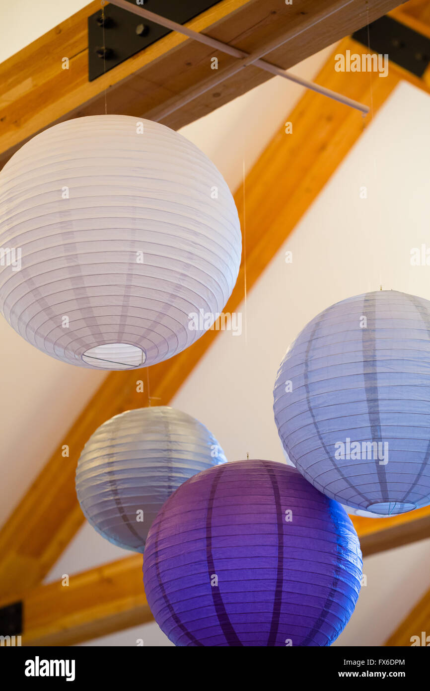 Chinese Of Japanese Paper Lanterns Hang From Wood Rafters At A