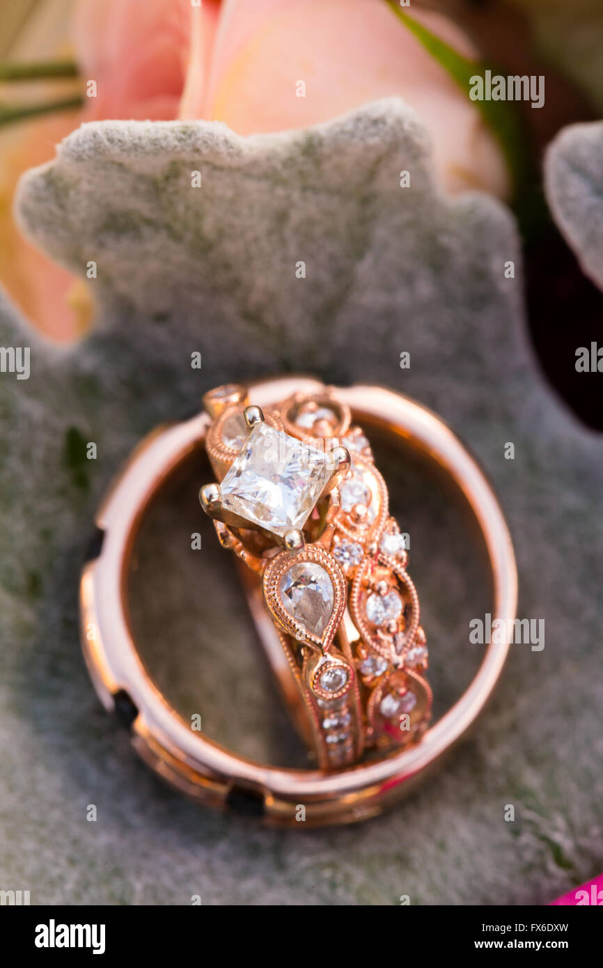 Custom made wedding rings for the bride and groom made out of rose gold ...