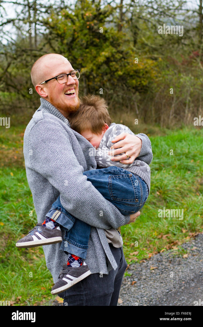 Dad and his son together in a lifestyle family portrait outdoors in the Fall. Stock Photo