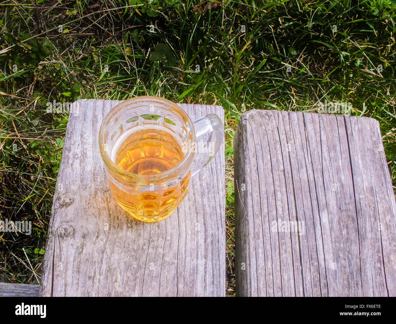 Mug of beer on a bench Stock Photo