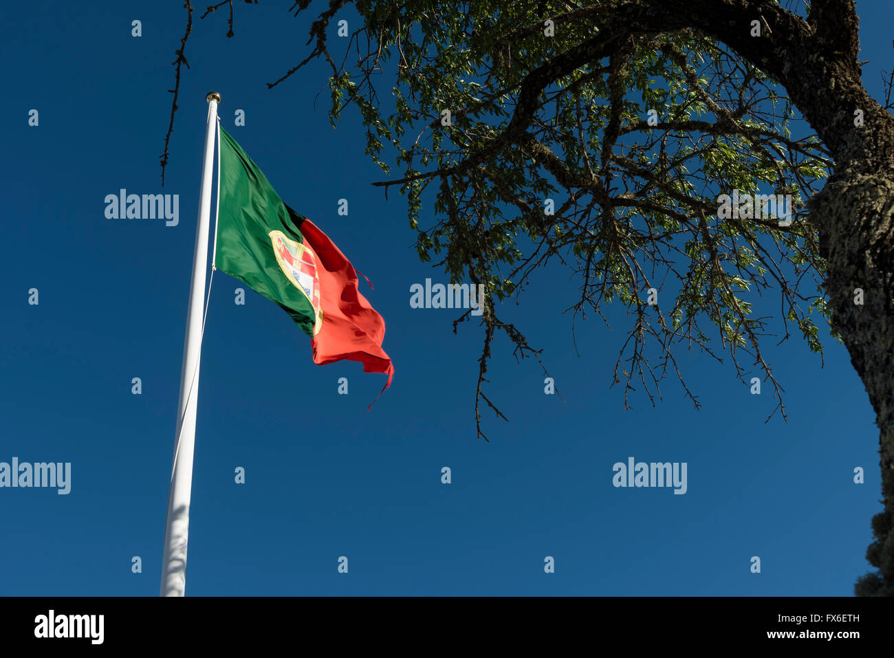 The Portuguese national flag flying over the fort of Alcoutim, Algarve, Portugal. Stock Photo
