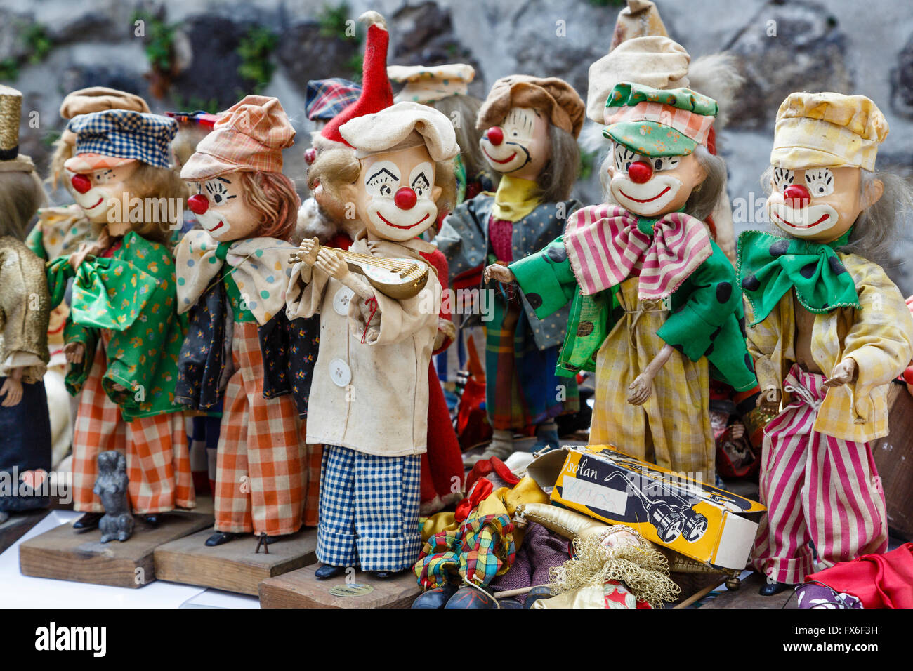 Clown dolls on sale at a vide-grenier in Allègre, Haute-Loire, France Stock Photo