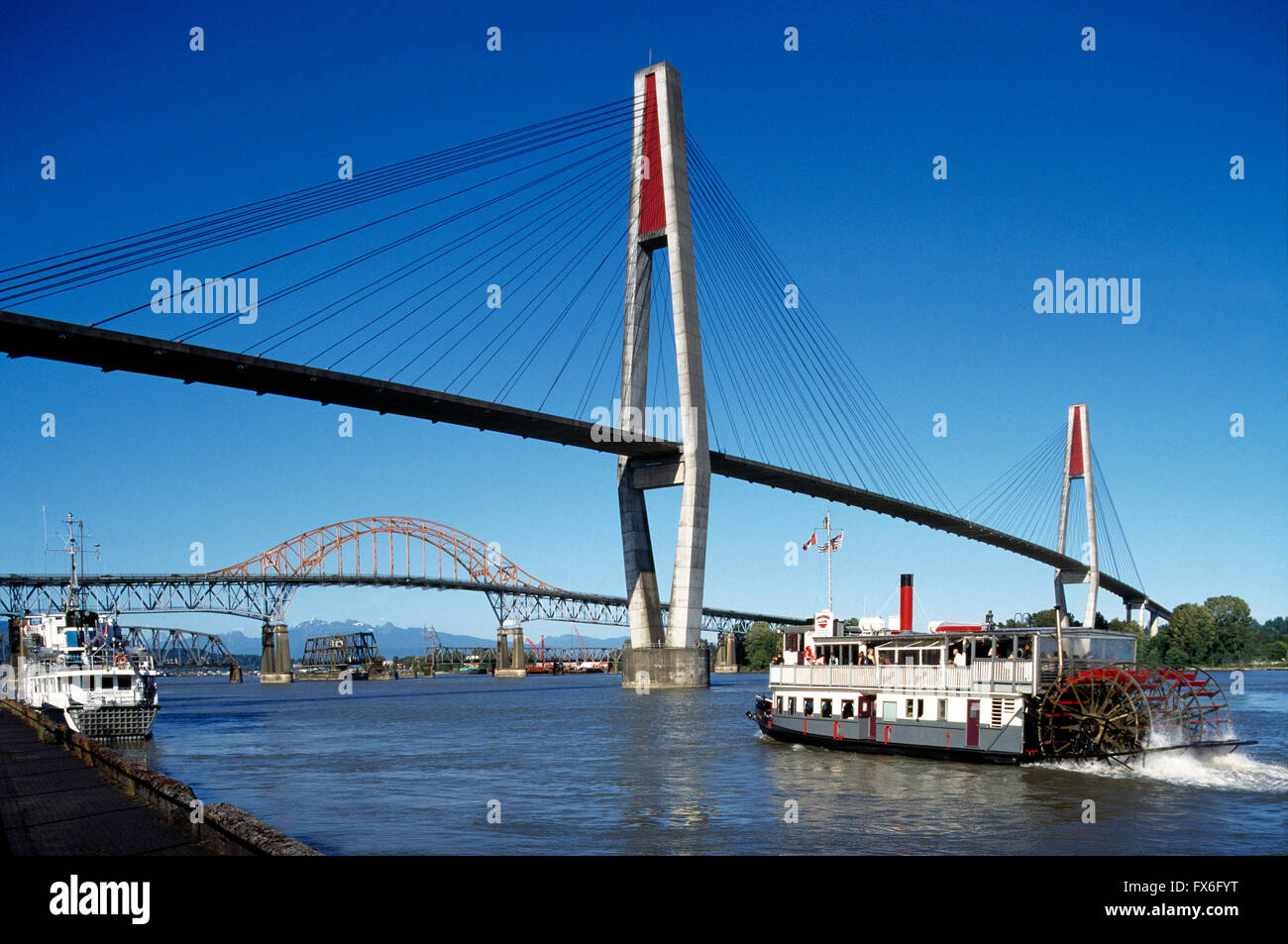 Paddlewheeler Riverboat Tour on Fraser River, New Westminster, British Columbia, Canada - SkyBridge and Pattullo Bridge behind Stock Photo