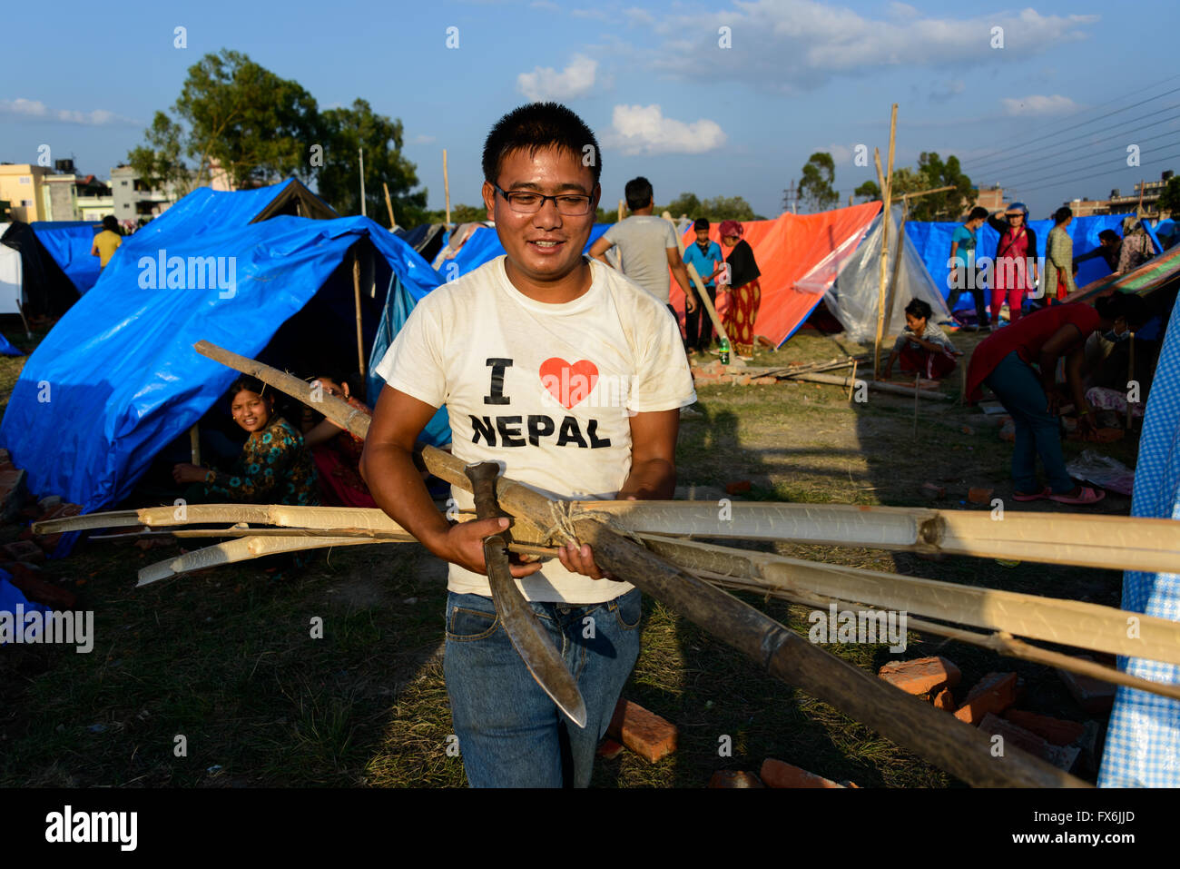 Kathmandu, Nepal - 12 May 2015: Man builds a tent in the Chuchepati area of Kathmandu, after the 7.3 magnitude earthquake. Stock Photo