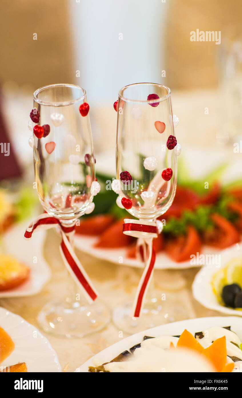 Close Up Of Wedding Decorated Champagne Glasses On The Table Stock