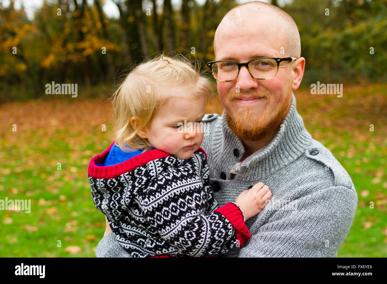 Lifestyle portrait of a father and his daugher outdoors in the Fall. Stock Photo
