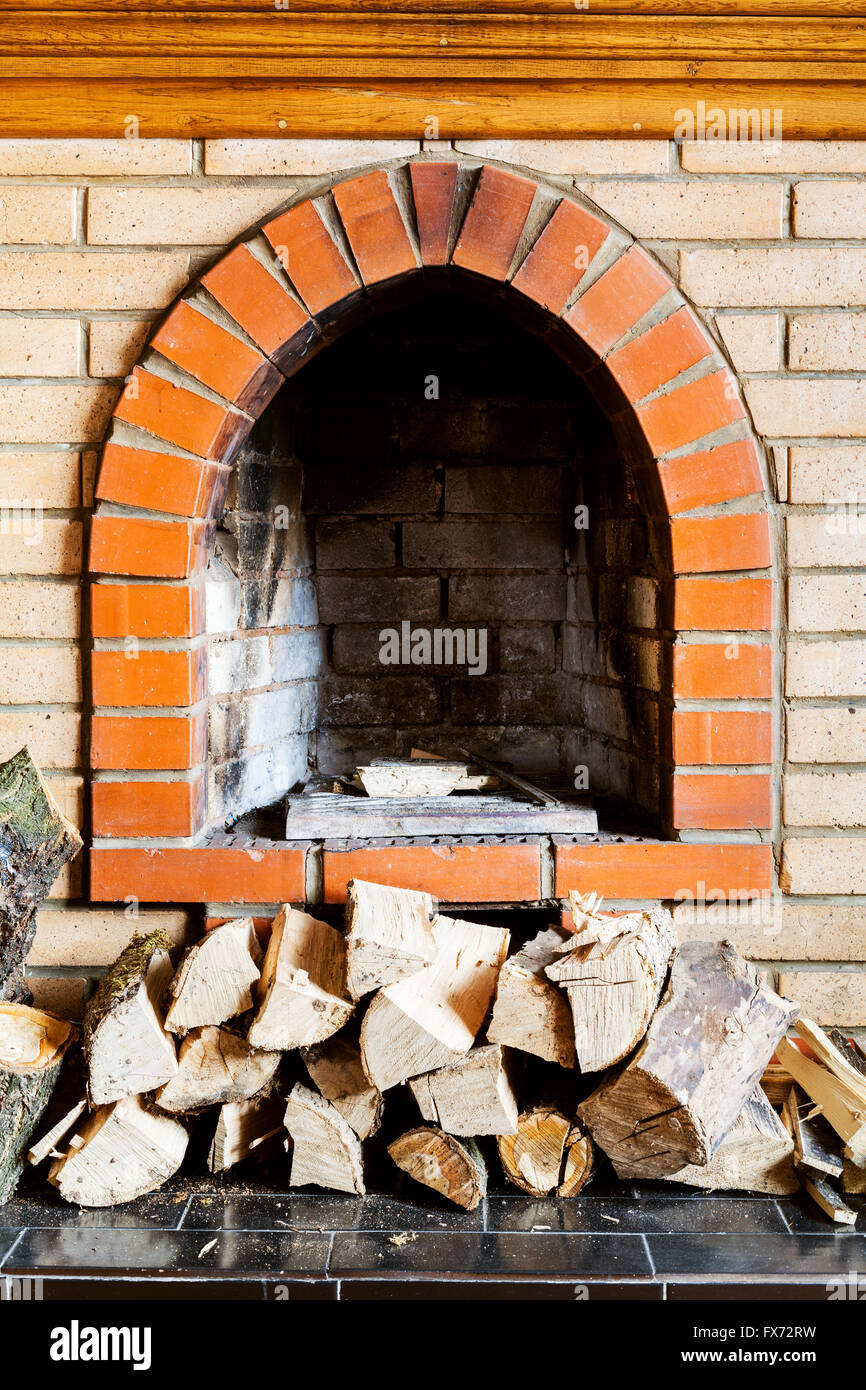 not kindled brick fireplace and wood logs indoor Stock Photo
