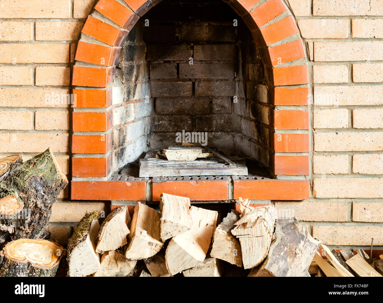 not kindled brick fireplace and firewoods indoor Stock Photo