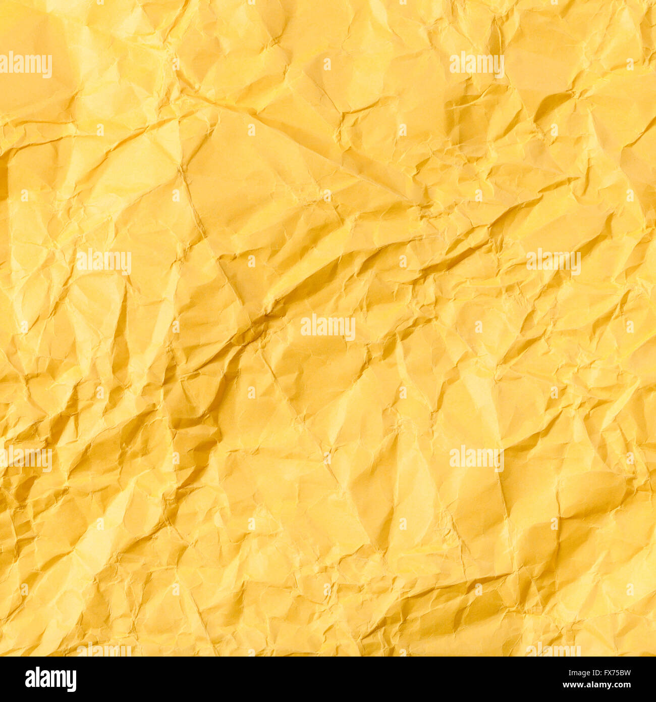 Vivid yellow color crumpled paper texture background Stock Photo