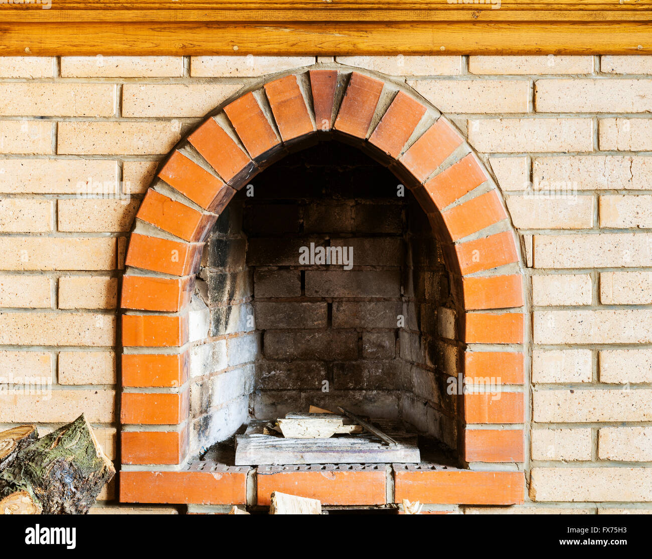 fire-box of not kindled brick fireplace indoor Stock Photo