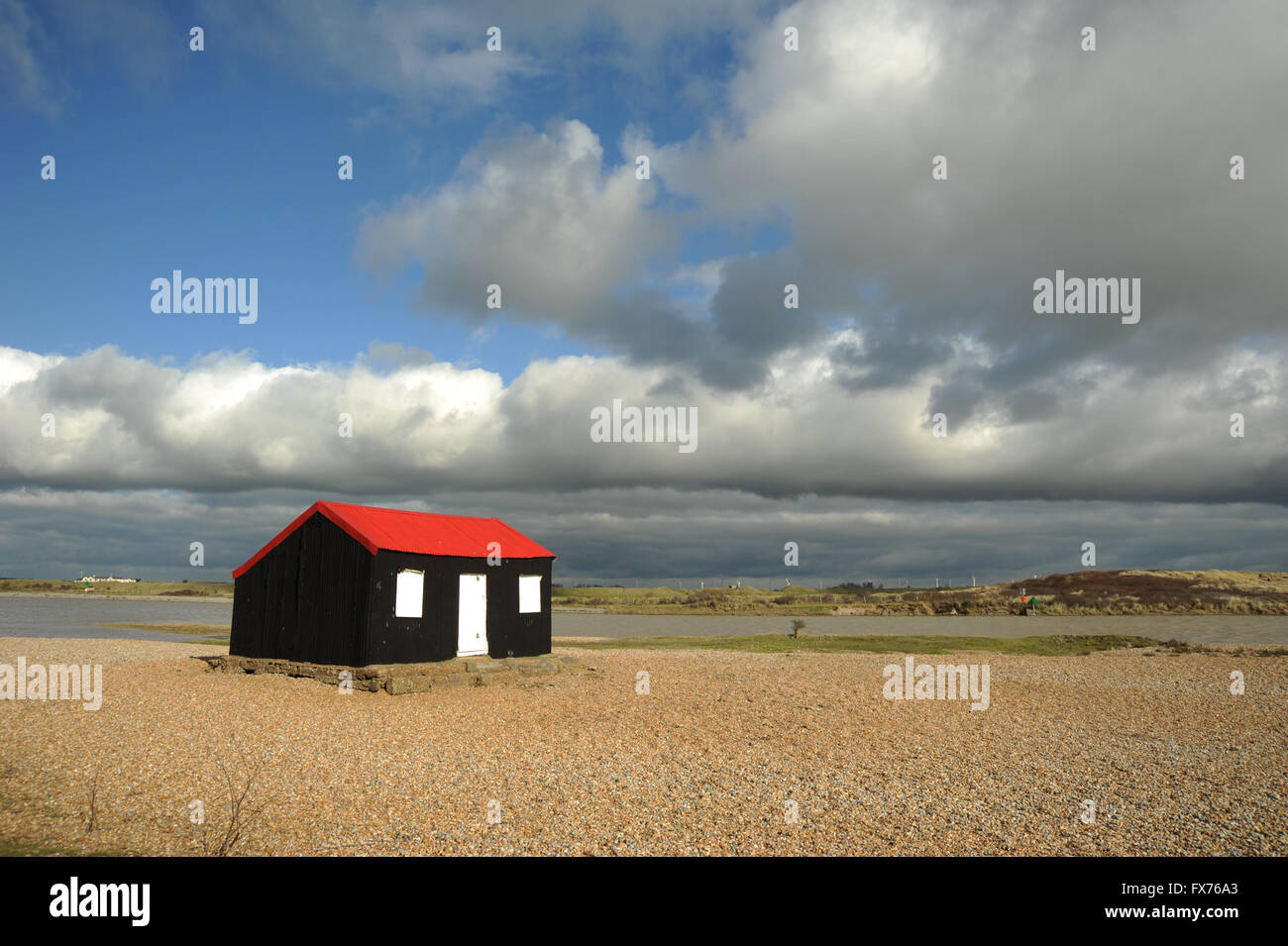 Fisherman's cottage at Rye harbour with Blue sky and clouds Stock Photo
