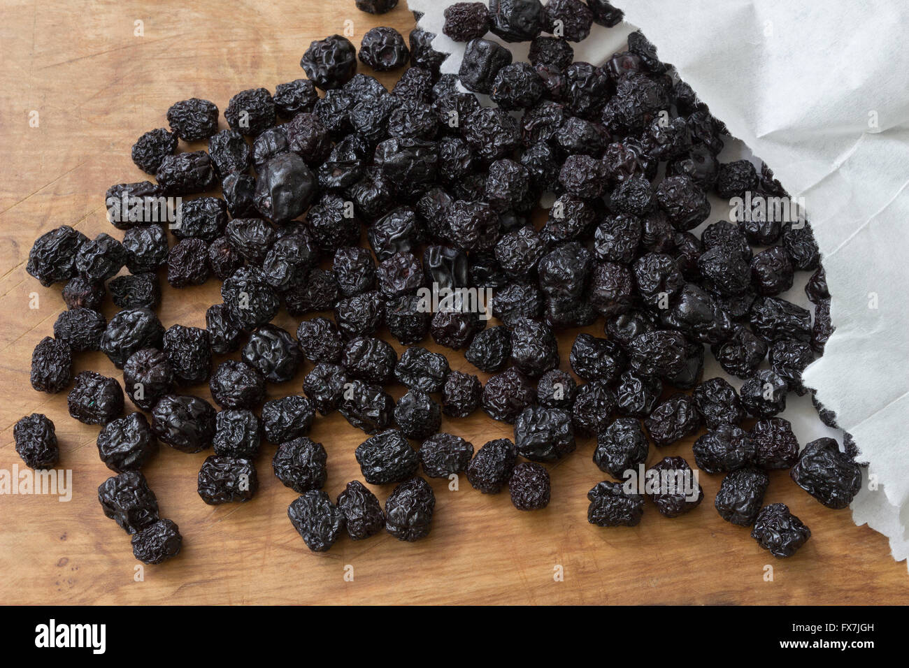 Dried aronia on a wooden table Stock Photo