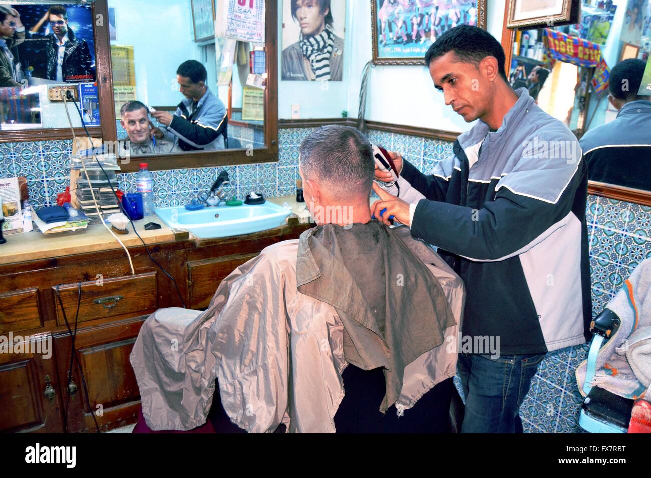 Barber cut the male customer's hair in barbershop , Tunisia Stock Photo