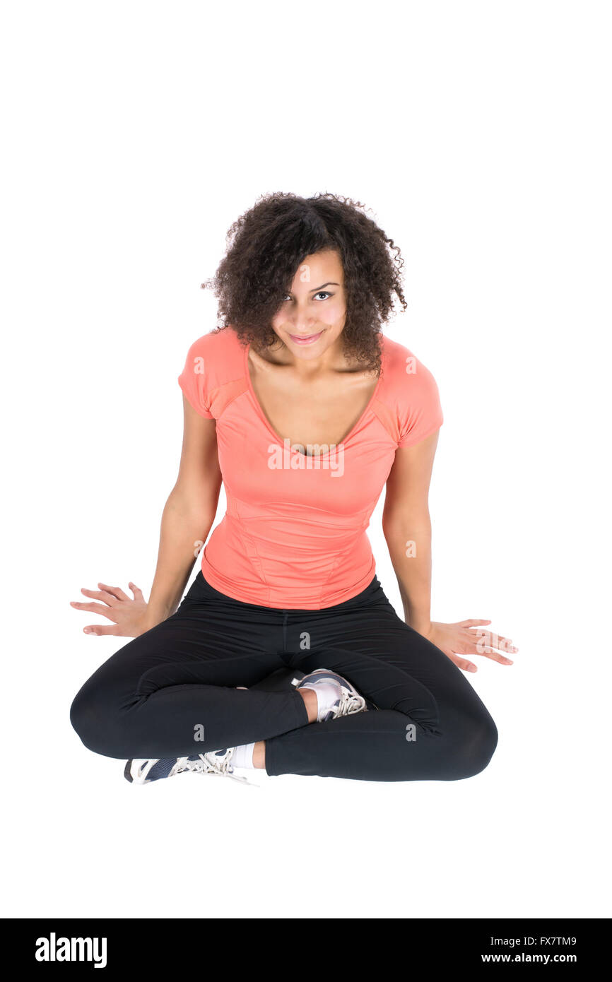 Cut out image of a young woman wearing sports wear who is sitting cross-legged Stock Photo