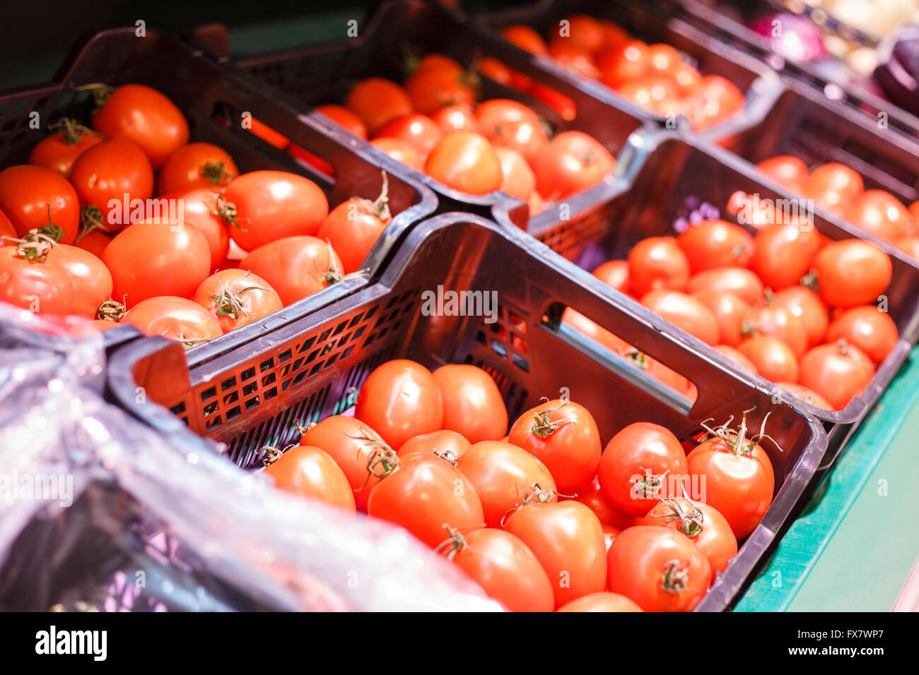 Red ripe tomatoes in boxes in a store. Vegetarian food background Stock ...