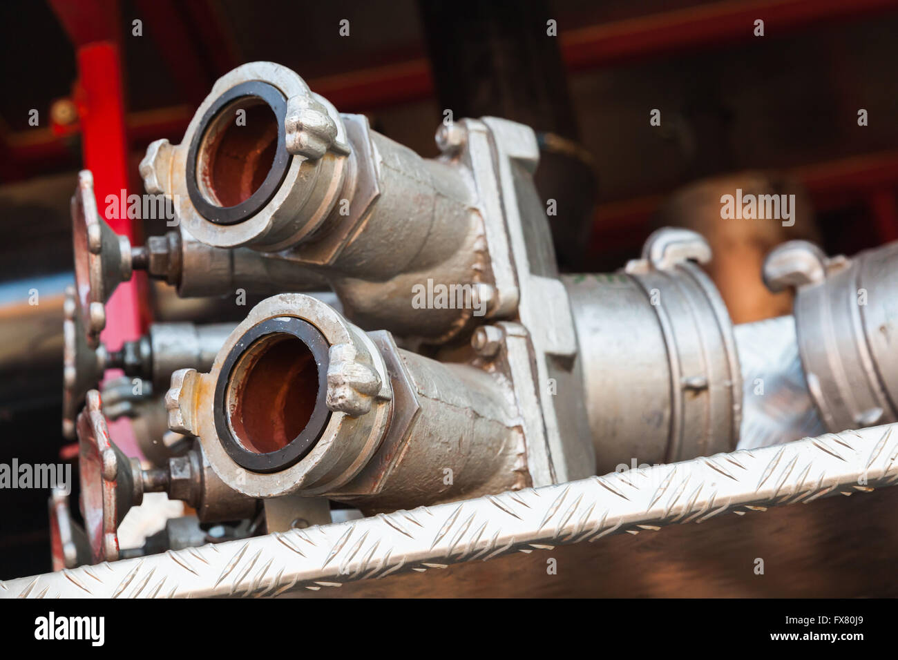 Firefighting equipment on red fire truck. Water hydrants close-up photo with selective focus Stock Photo