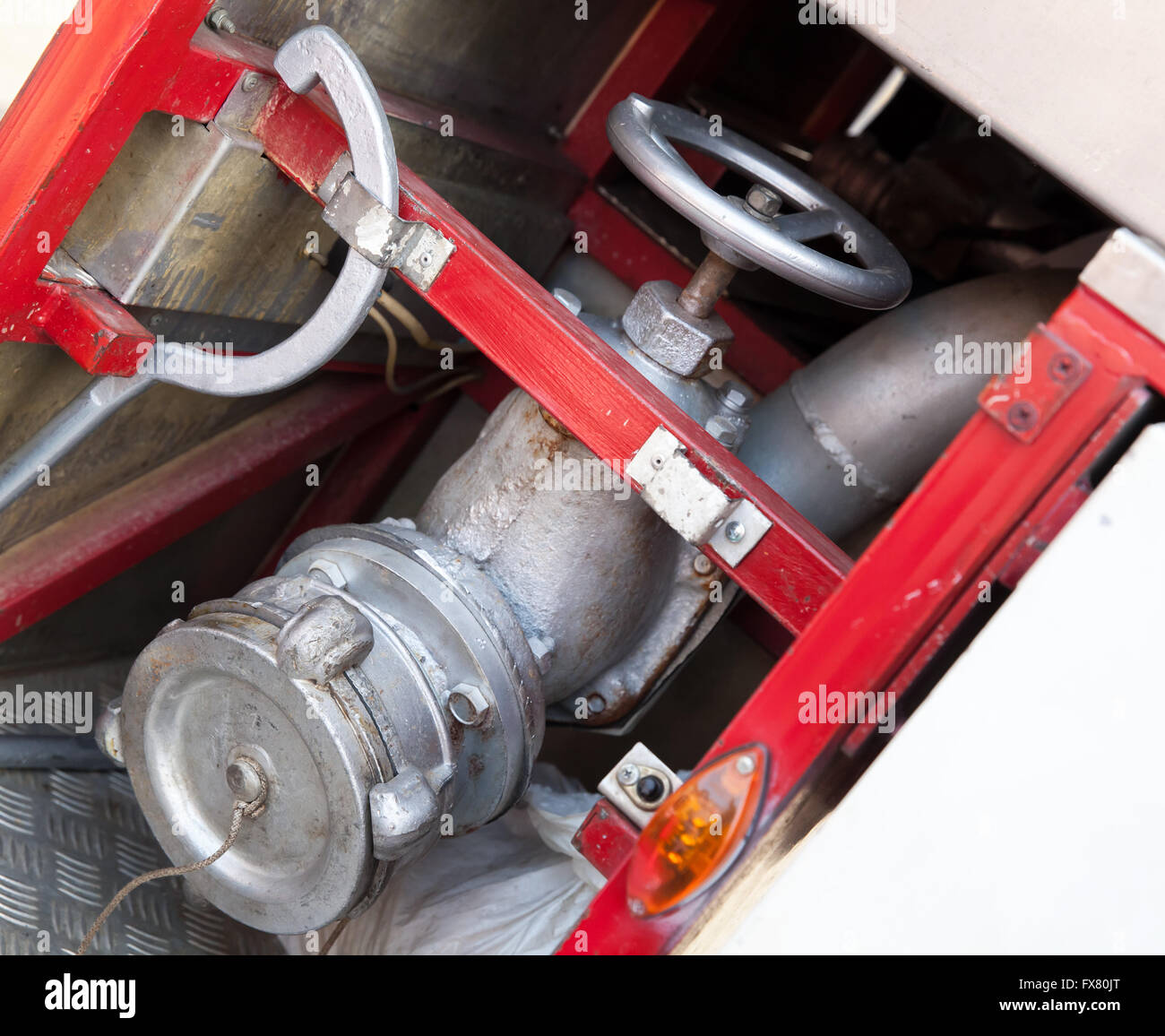 Firefighting equipment on red fire truck. Water hydrant closeup photo with selective focus Stock Photo