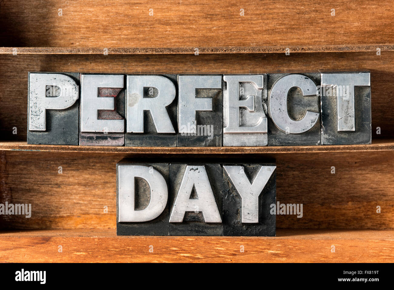 perfect day phrase made from metallic letterpress type on wooden tray Stock Photo