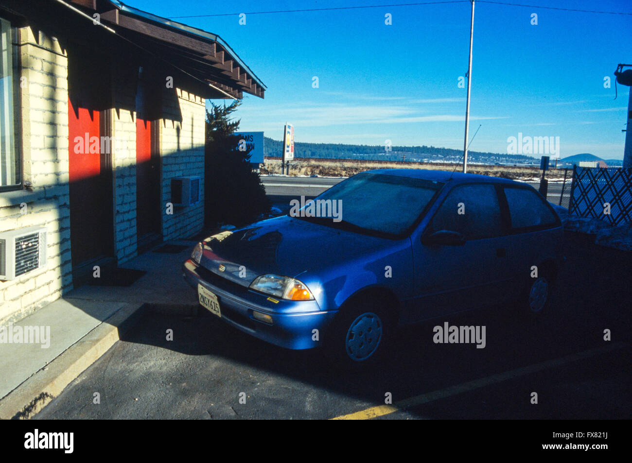 Archive image of a metallic blue 1990 model Geo Metro 3-door subcompact hatchback car outside a motel in Williams, Arizona, USA, 1990 Stock Photo