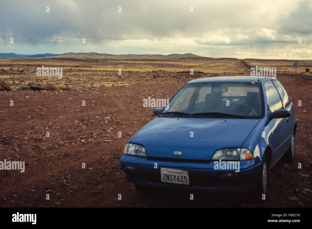 Archive image of a metallic blue 1990 model Geo Metro 3-door subcompact hatchback car parked at Meteor Crater, Arizona, USA, 1990 Stock Photo