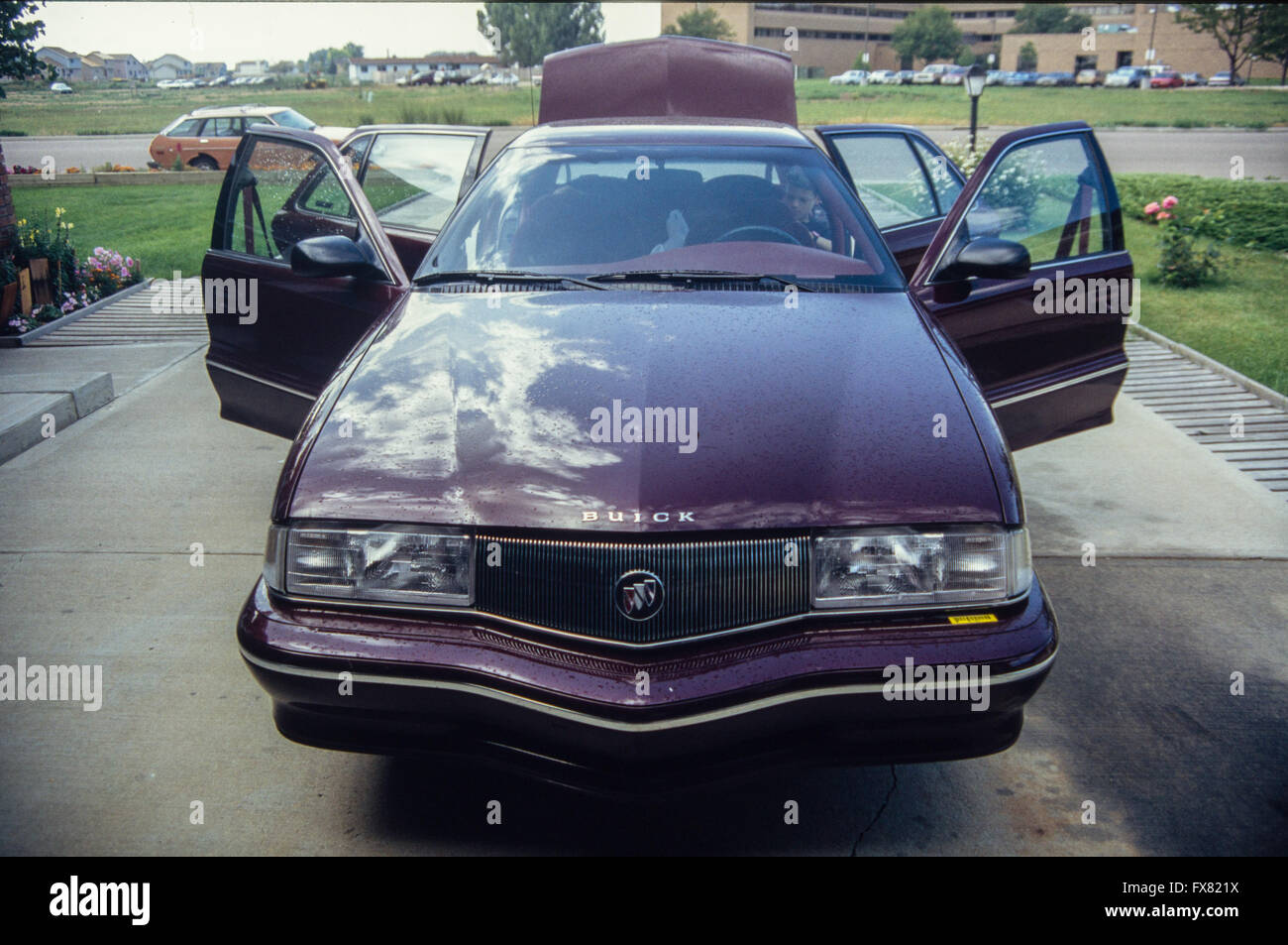 Archive image of a maroon 1992 model General Motors Buick Skylark compact 4-door sedan saloon car, USA, 1992, with doors and boot open Stock Photo
