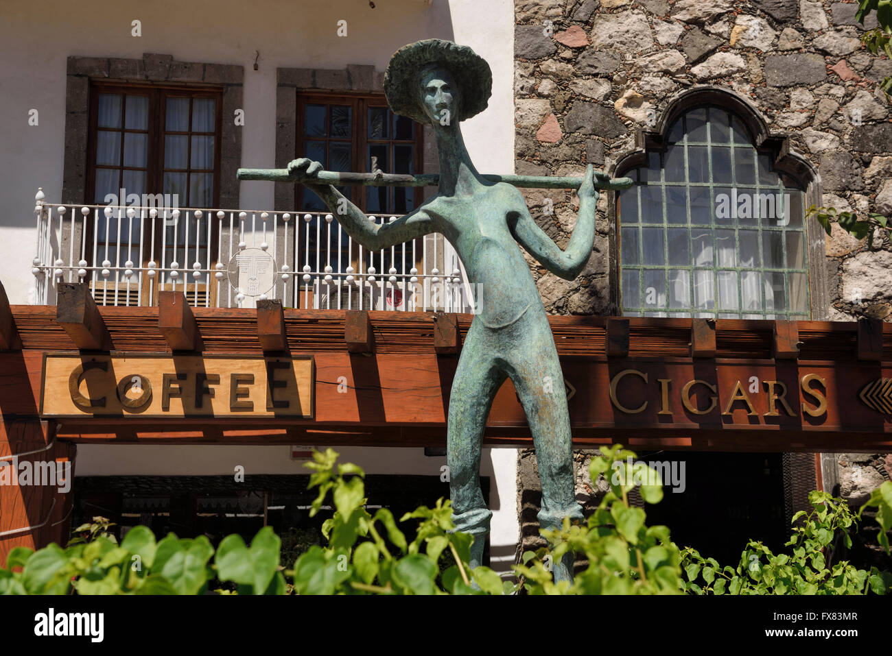 Cigar and coffee shop in downtown Puerto Vallarta with statue of Fisherman Stock Photo