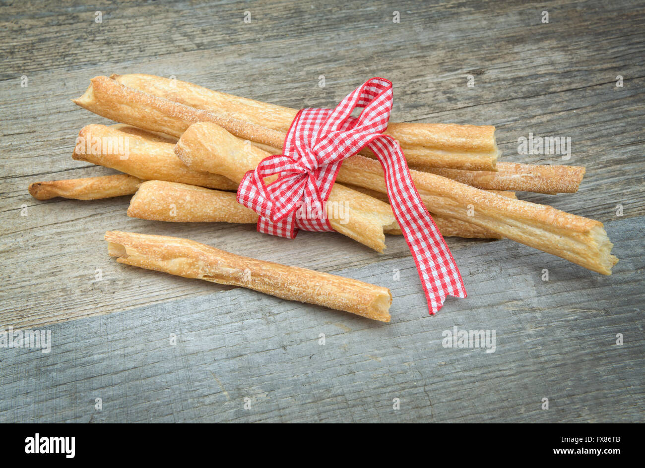 Breadsticks on wooden table with ribbon Stock Photo