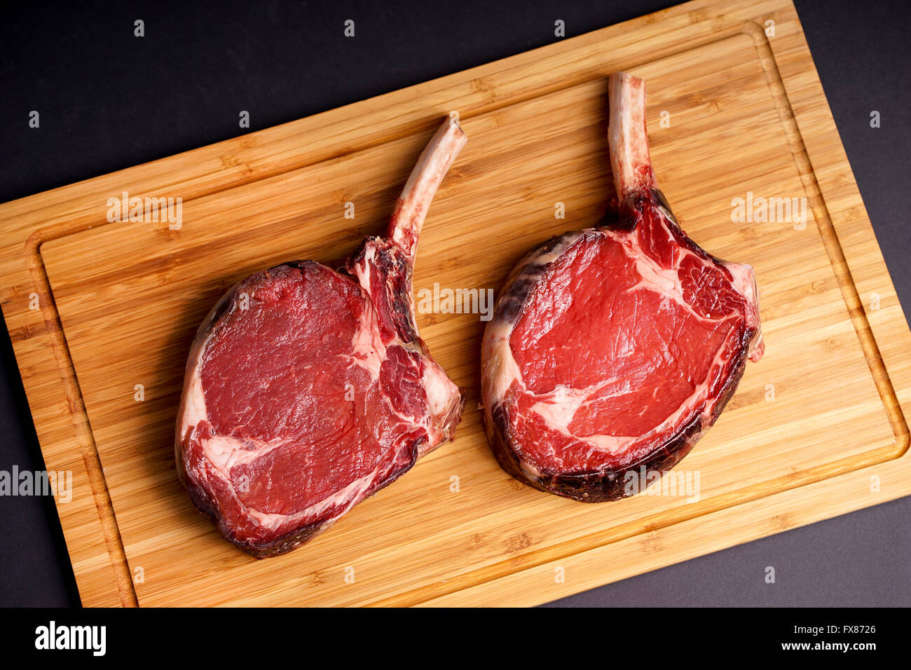 Raw Dry aged tender delicious Tomahawk Steak Stock Photo