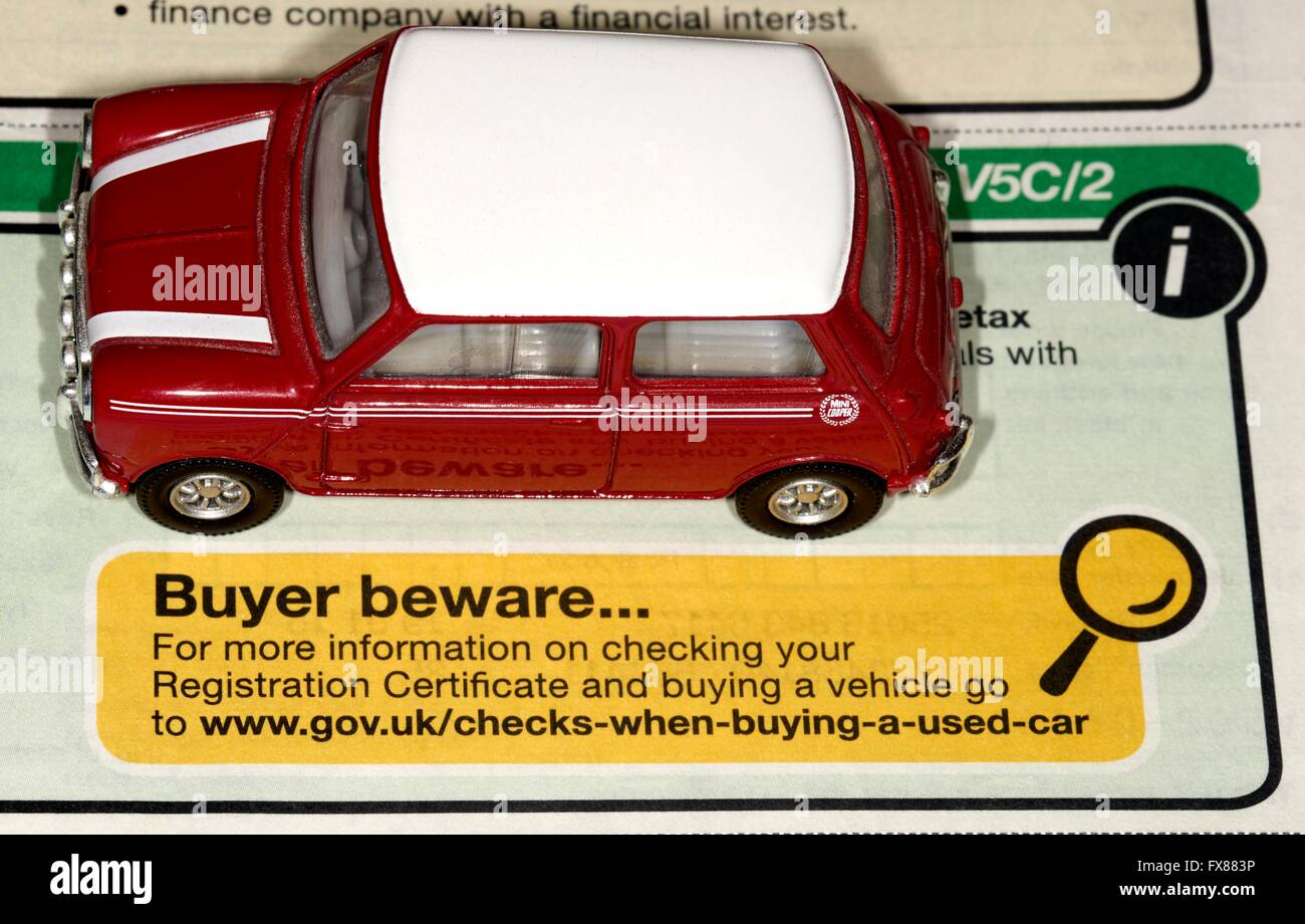 A red mini cooper above a DVLA buyer beware message Stock Photo
