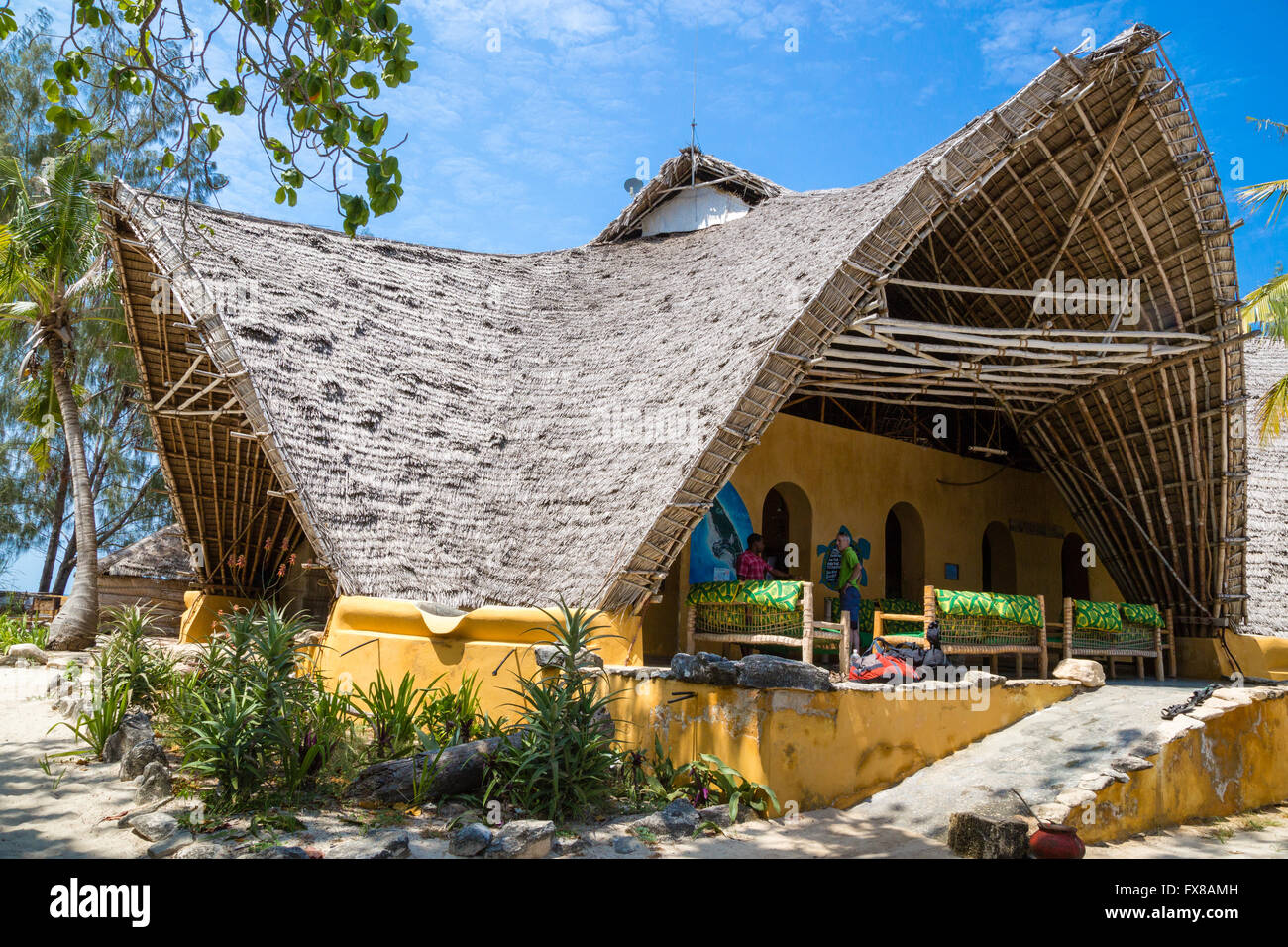 Palm thatched roof of the big open visitor centre on Chumbe Island off the coast of Zanzibar East Africa Stock Photo