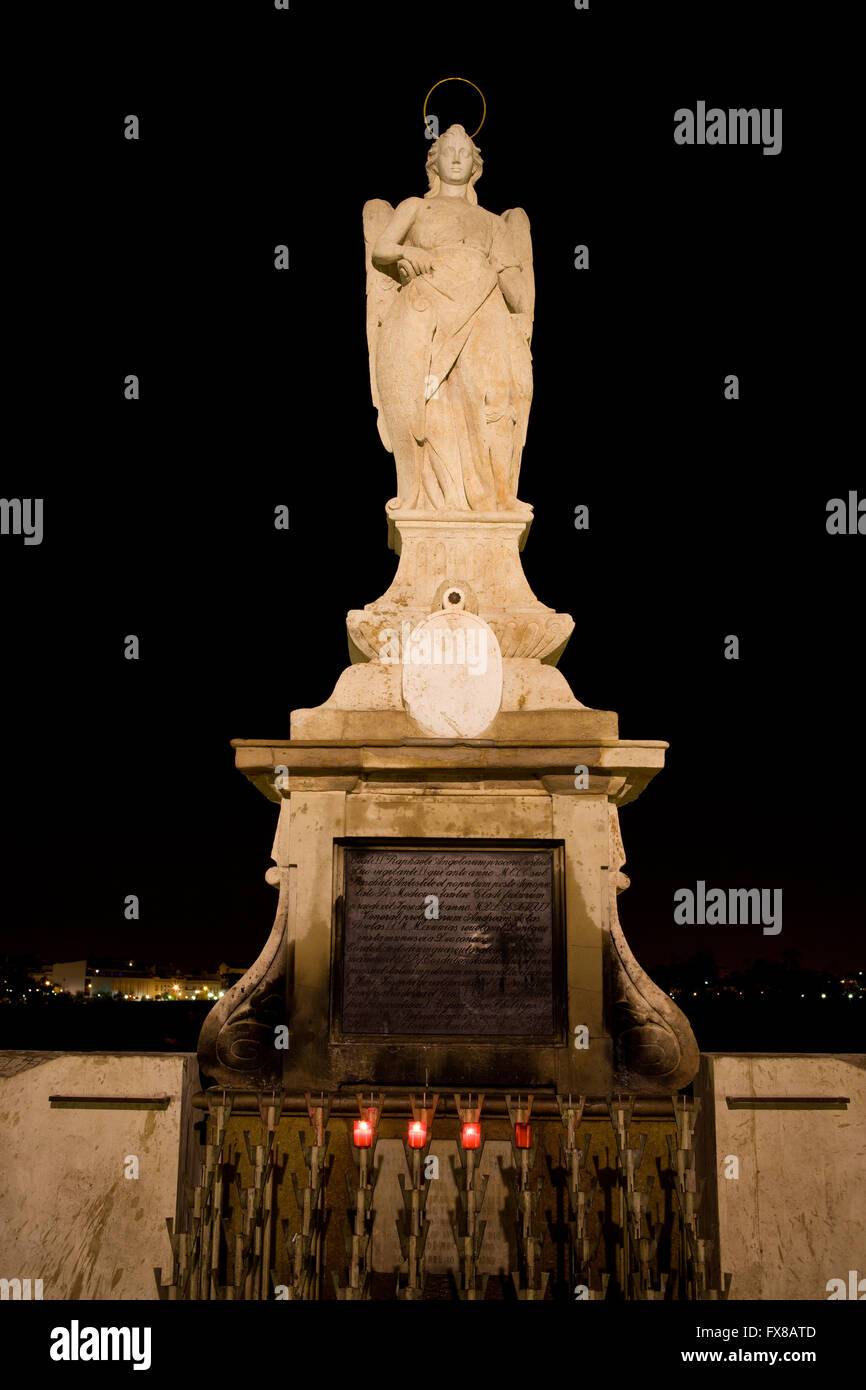 San Rafael, archangel Saint Raphael statue from 1651 at night, small shrine on Roman Bridge in Cordoba, Andalusia, Spain, city p Stock Photo