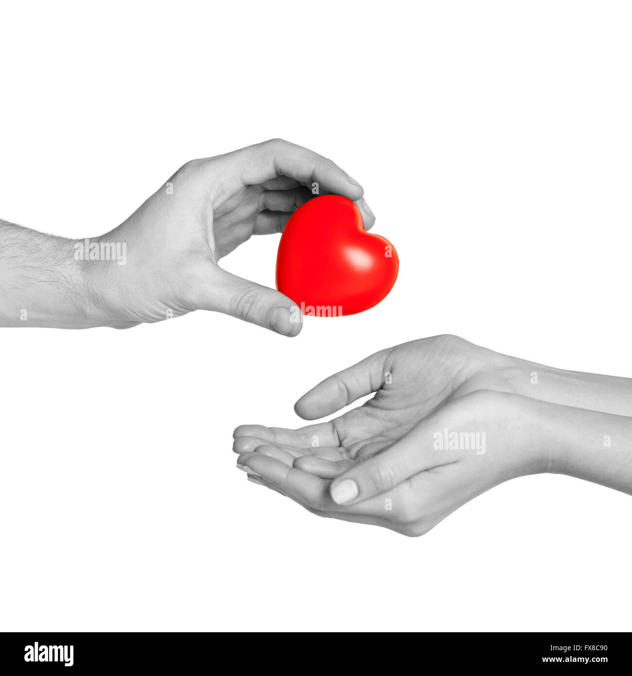 man hand giving red heart to woman Stock Photo - Alamy