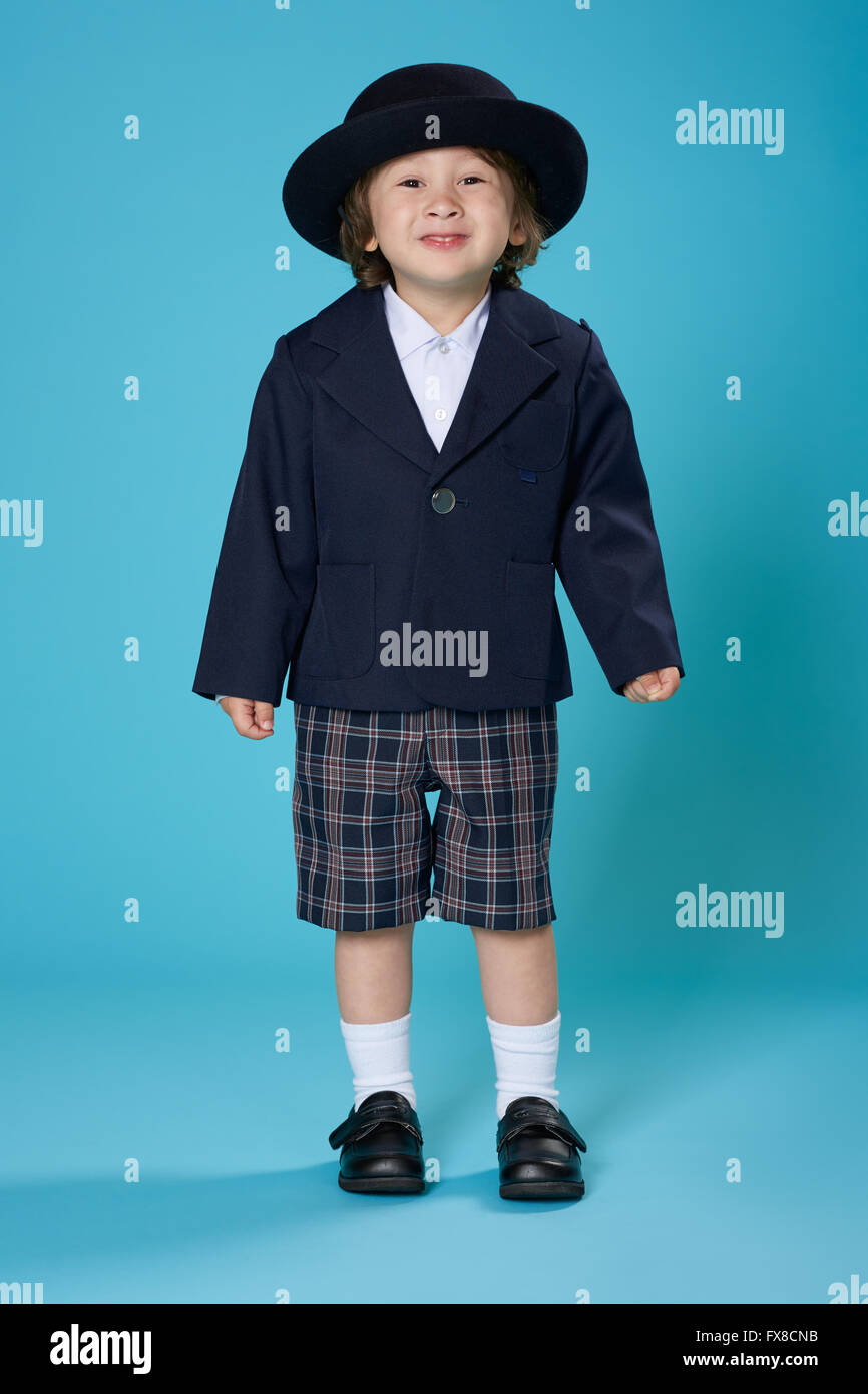 A 3 year old half Japanese, half American boy dressed in a preschool uniform. Stock Photo