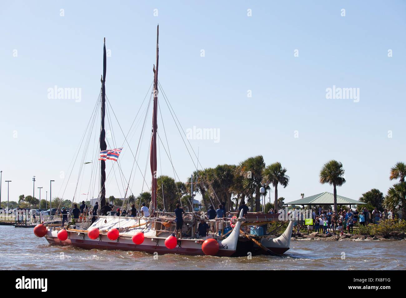The Polynesian traditional voyaging canoe Hokulea sails the Indian River before stoping to honor Hawaiian astronauts near the Kennedy Space Center April 5, 2016 in Titusville, Florida. The traditionally designed, ocean-going Hawaiian canoe is sailing around the world demonstrating ancient navigation techniques and to raise awareness of climate change. Stock Photo